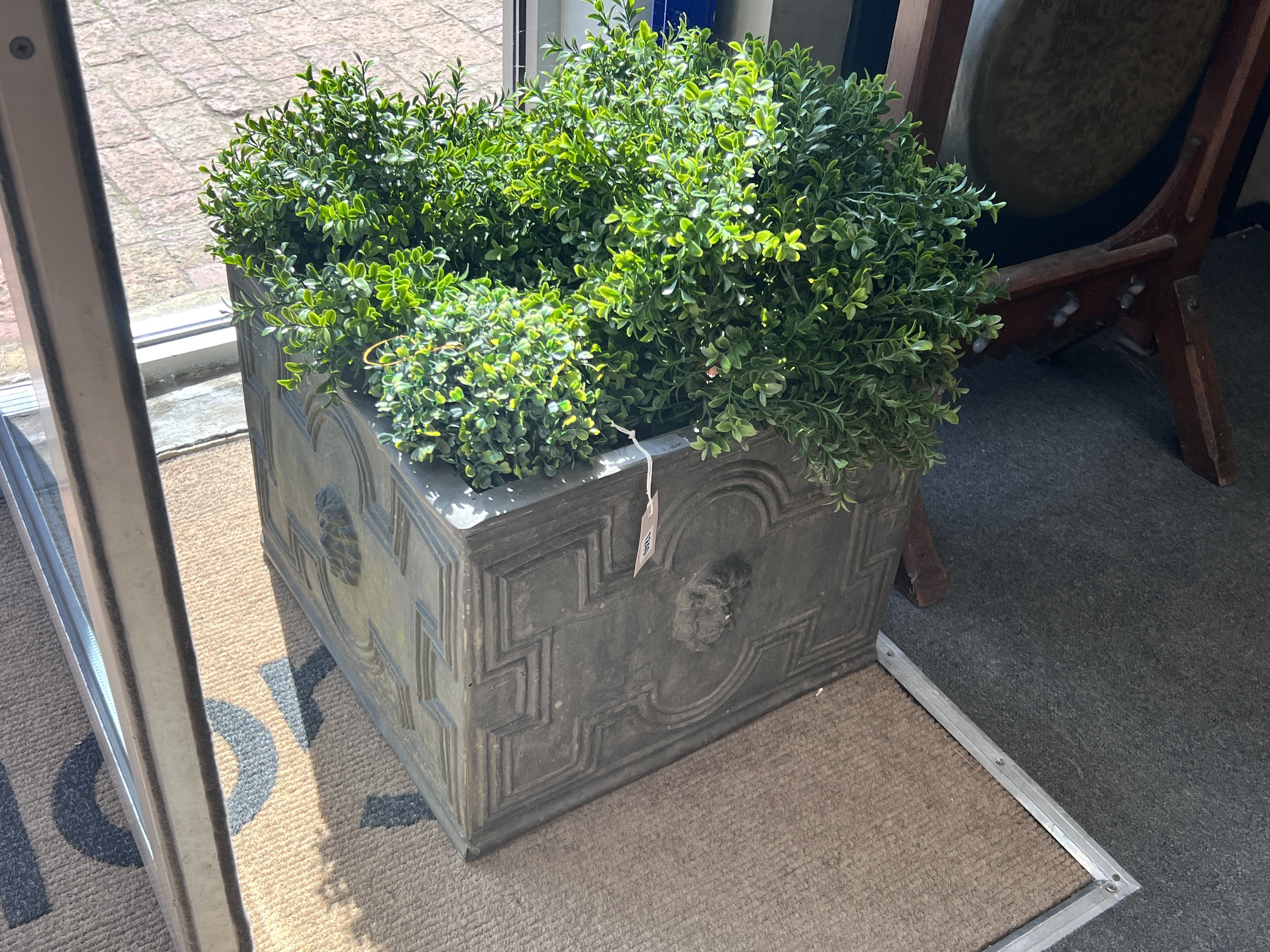 A pair of square faux lead square planters with faux box balls, width 50cm, height 40cm